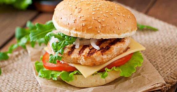 Sandwich with chicken burger, tomatoes, cheese and lettuce